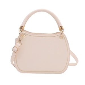 Cream PU leather saddle bag with gold stitching and adjustable strap on white background