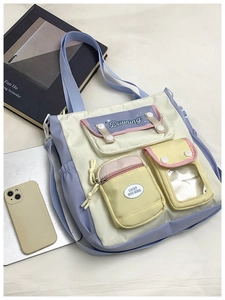 Detail of multi-pocket contrast color nylon crossbody bag with adjustable purple strap