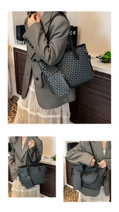 Macro view of geometric pattern tote bag featuring premium leather texture and metal rings