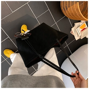 Top-down view of a spacious black tote bag made of matte fabric for daily commuting