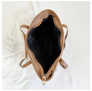 Top view of large brown tote bag with zipper closure and spacious interior storage