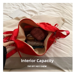 Detail showing the large interior capacity of this red tote bag with daily essentials