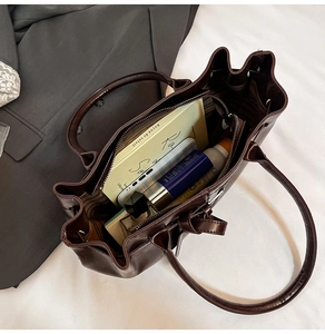 Top-down view of a spacious brown tote bag showing its large storage capacity with daily items