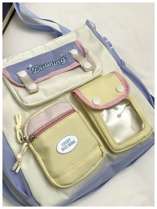 Detail of multi-pocket patchwork canvas crossbody bag with pastel contrast panels