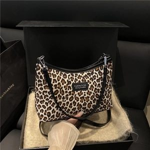 Vintage leopard print shoulder bag with black leather straps and silver metal hardware