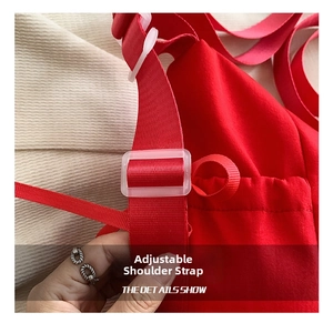 Macro view of adjustable red nylon shoulder strap with transparent buckle on casual bag