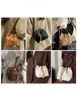 Dettaglio borsa a secchiello con coulisse di perle e tracolla a catena elegante