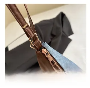 Detail of premium gold zipper and brown leather with blue denim fabric stitching