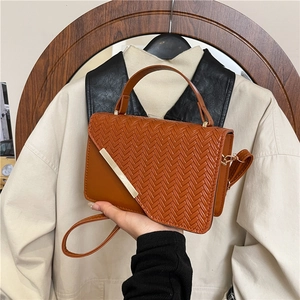 Brown woven crossbody bag with gold metal trim and adjustable shoulder strap for women