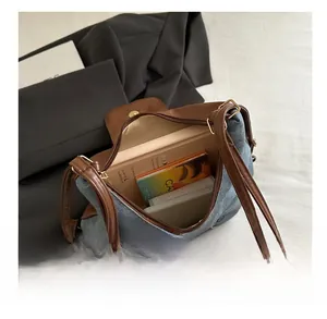 Detail showing the large interior capacity of this retro blue denim shoulder bag