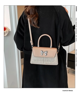 Champagne bow shoulder bag with sequin detail and silver buckle shown on model