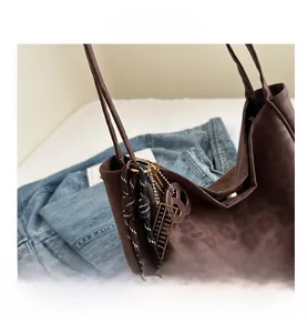 Close-up of leopard pattern tote bag with decorative rope knots and golden abacus charm