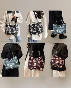 Detail shots of large capacity tote bag featuring skull floral prints and chain straps