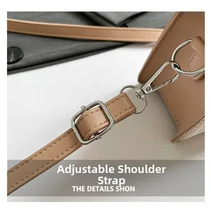 Detail of adjustable camel faux leather shoulder strap with silver metal buckle hardware
