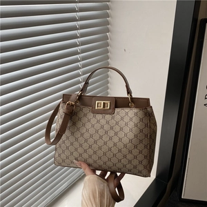 Sac seau vintage à monogramme avec garniture en cuir marron et fermoir doré en métal