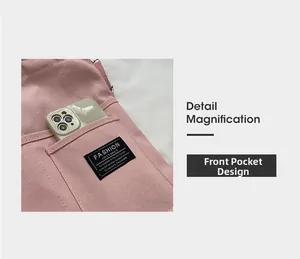 Detailed shot of pink canvas bag front pocket featuring fashion label and a smartphone