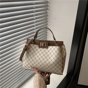 Sac seau vintage à monogramme avec finitions en cuir marron et fermoir tournant