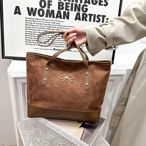 Large capacity brown tote bag with suede paneling and golden bow detail for women