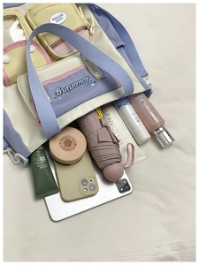 Detailed top view of a multi-pocket canvas tote bag showing large storage capacity