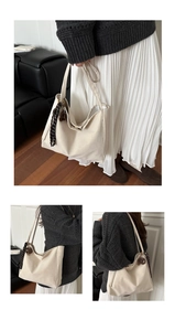 Detail of cream tote bag with checkered silk scarf accessory and spacious interior