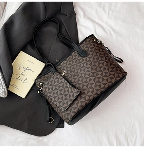 Detail of printed tote bag and small zip pouch on a black blazer with geometric pattern