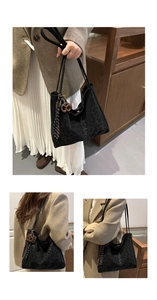 Detail of black leopard print tote bag featuring wooden charm and striped tassel accent
