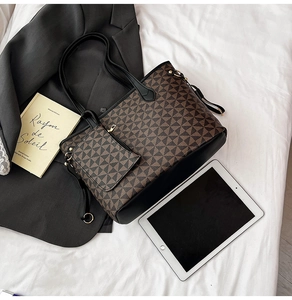 Detail of large geometric print tote bag with matching pouch and black leather handles