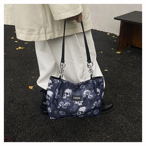 Close-up of floral skull print tote bag with metal chain handles and Fashion tag