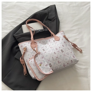 Detail of white leather tote bag with pink heart prints and matching small coin purse