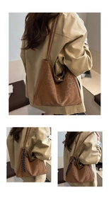 Detailed view of brown leopard print tote bag featuring a striped woven keychain charm