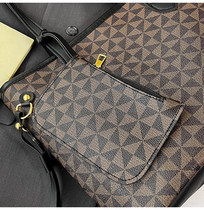 Close-up of vintage tote bag with geometric print and matching accessory pouch