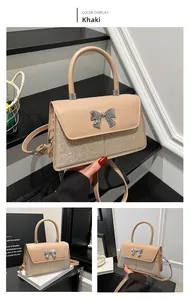 Detail of khaki crossbody bag featuring sequin patchwork and silver bow metal buckle