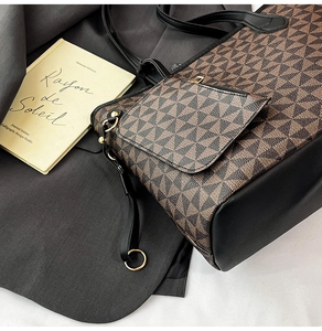 Detail of vintage tote bag featuring geometric patterns and durable black leather base