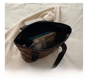 Top view of spacious brown quilted tote showing large capacity for umbrella and essentials
