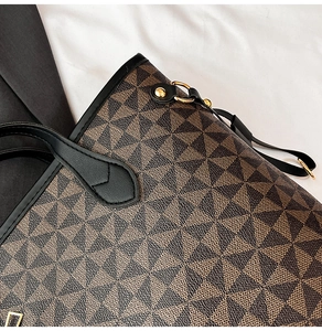 Close-up of vintage geometric pattern and golden metal hardware on a large tote bag