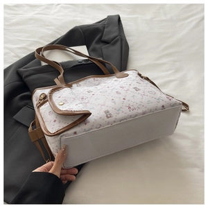 Detail of white tote bag with cute bear prints and matching brown shoulder straps