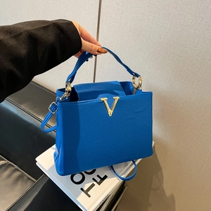 Sac à main élégant bleu roi en cuir grainé avec un fermoir en V doré très distinctif