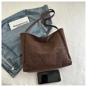 Detailed view of large leopard print tote bag with soft matte texture and spacious design