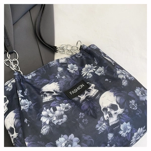 Close-up of gothic skull and purple floral print on the textured tote bag surface