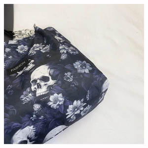 Macro detail of gothic skull and purple floral print on large capacity tote bag