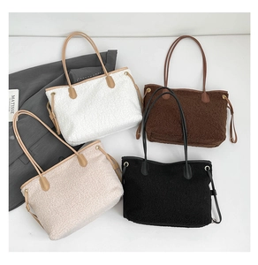 Flat lay of sherpa tote bags in four colors with leather straps and drawstring details