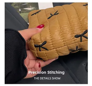 Macro shot of quilted ginger handbag showing soft fabric and precise stitching detail