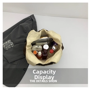 Top view of large brown pleated tote bag showing spacious interior with tablet and cosmetics
