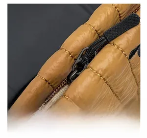Close-up of quilted brown cosmetic bag featuring premium black zipper and non-slip puller