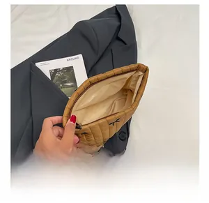 Interior view of brown quilted makeup bag with spacious compartment and bow detail