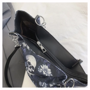 Close-up of silver zipper and hardware on Gothic skull and floral print tote bag
