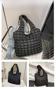 Close-up of quilted bubble texture and large capacity interior of black tote bag