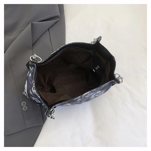Detail of the large printed tote bag interior showing dark brown lining and zipper pocket