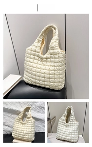 Detail of white quilted puffy tote bag showing soft texture and spacious interior design
