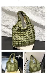 Detail of green quilted puffer tote bag showing bubble texture and spacious beige lining